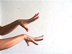 Laurana Wong - Hand Dance - The tanned fingers stretch and curve, dancing one atop one another in white room